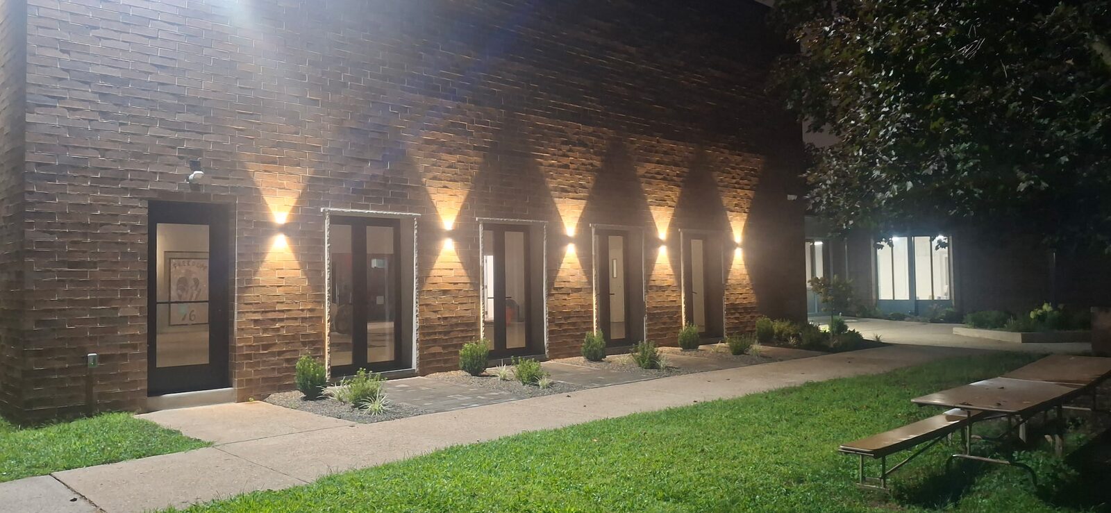 Manor Park brick courtyard illuminated at night