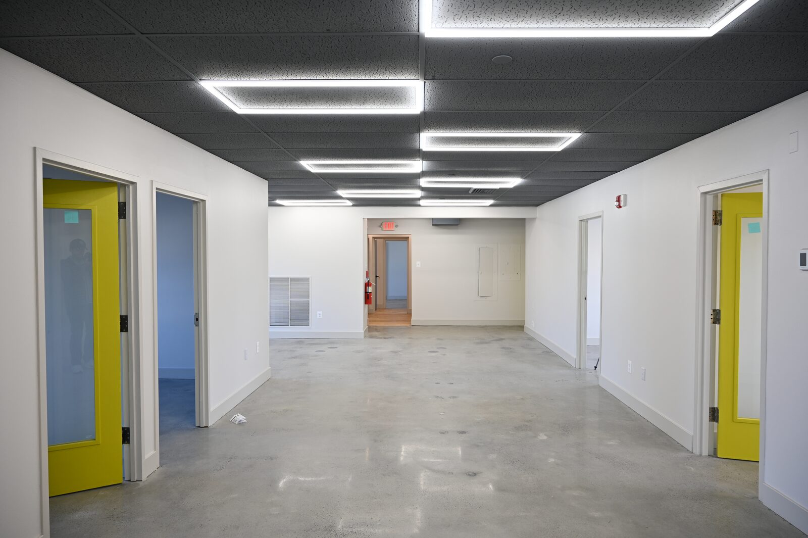 Bright studio corridor with colorful doors